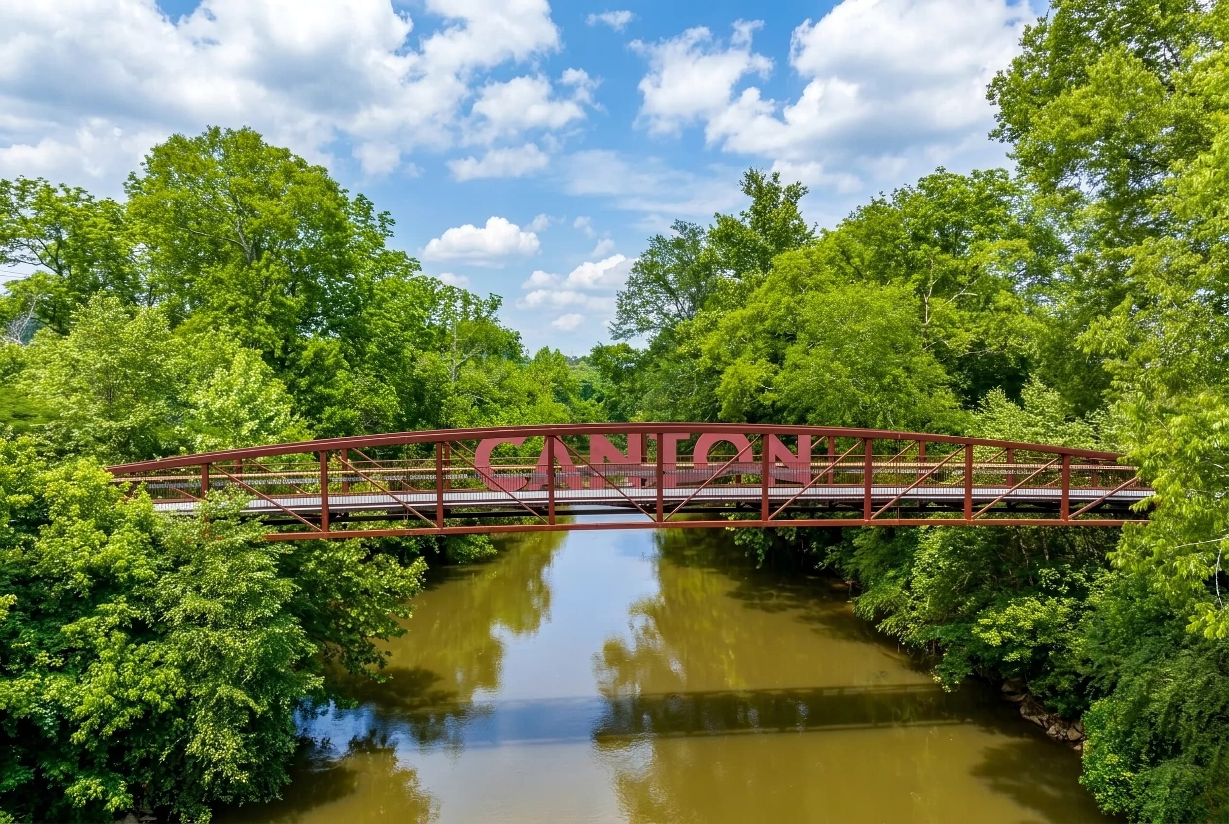 Aerial view of the red arched pedestrian bridge over the Etowah River in Canton, Georgia